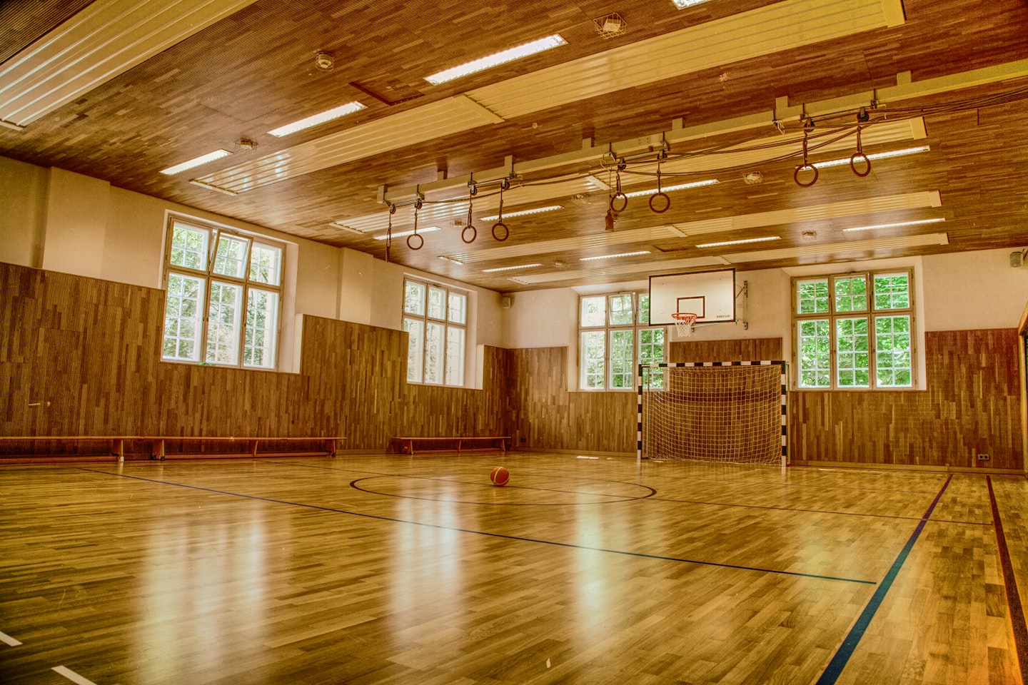 A school gym set up for a local fundraising event with tables and community activity