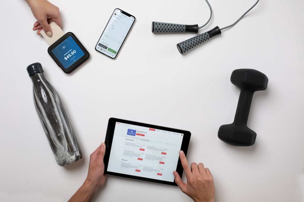 Fitness business owner using a phone app to manage paid sessions and subscriptions